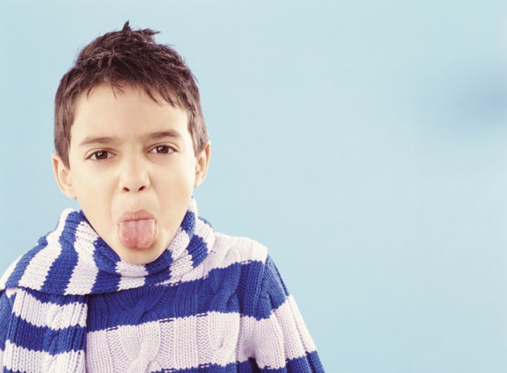 boy poking out tongue