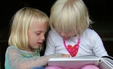 two girls reading book